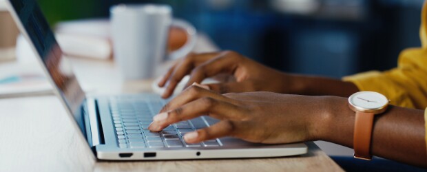 MBA recommendation letter writer typing out a recommendation letter on a laptop.