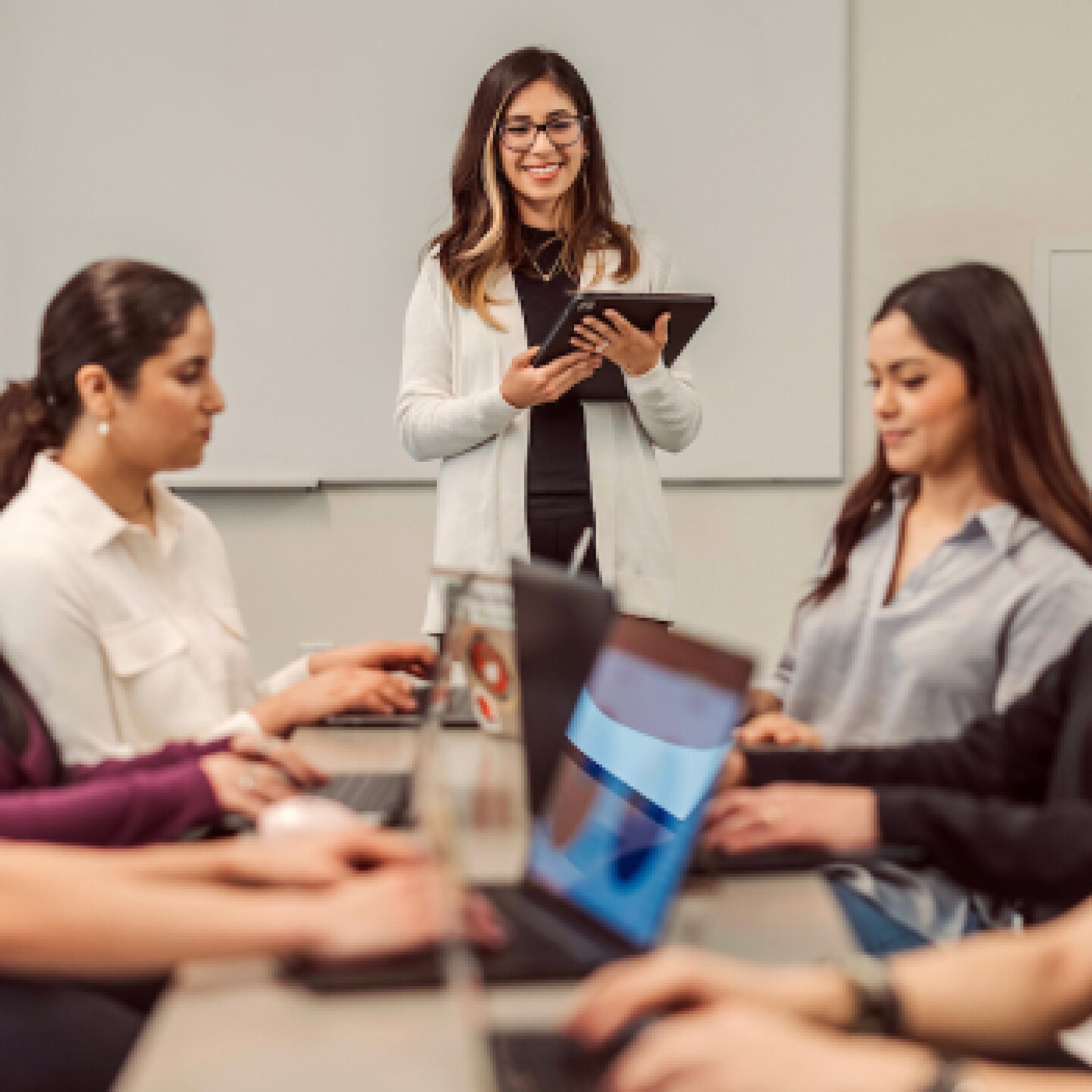 A group of female CSUMB students participate in the business simulation game.