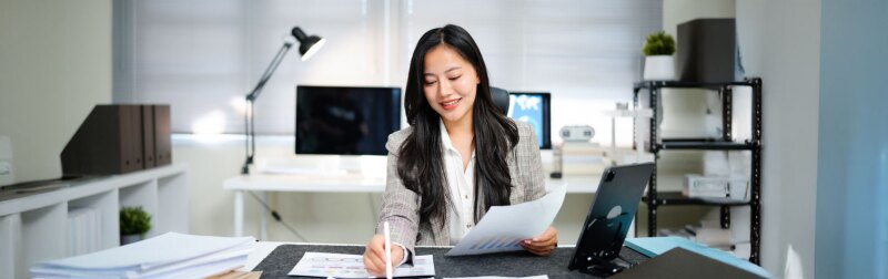 A female accountant check report for information, financial data or analysis.