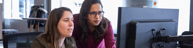 Two women looking at a computer screen