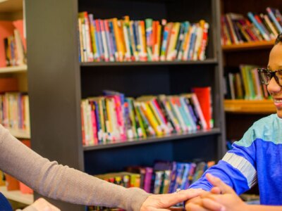 school counselor and teenage male student in counseling session