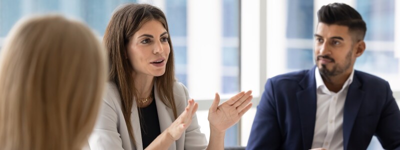 Female business executive leading a meeting of diverse colleagues