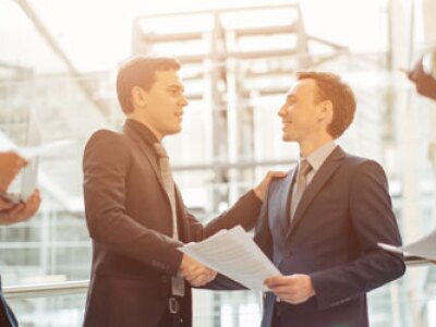Two men in suits shaking hands