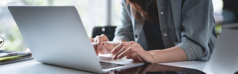 Businesswoman online working on a laptop computer.