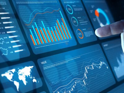Analyst working with Financial Data and Business Analytics Dashboard on computer to make Financial Report with KPI and Metrics.