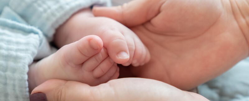 mom holding baby's feet