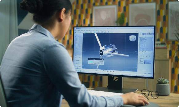 someone working on a computer with an engineering image on screen