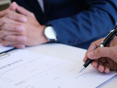Finance manager reviews a risk assessment report with a colleague during an office meeting.