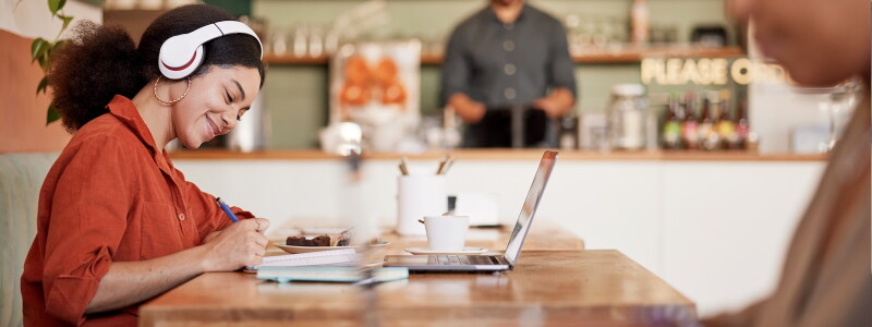 Woman, student in cafe working on personal statement for online MBA application