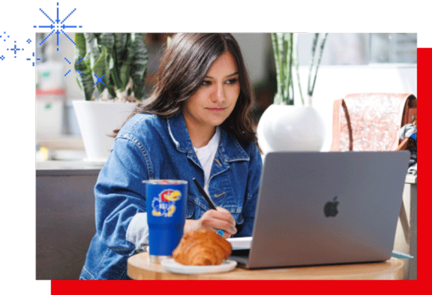 A female KU student is working on a laptop.