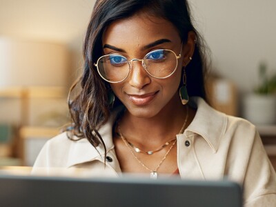 Business woman reading on laptop