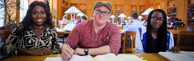 A diverse group of Tulane Law students studying in the campus library.