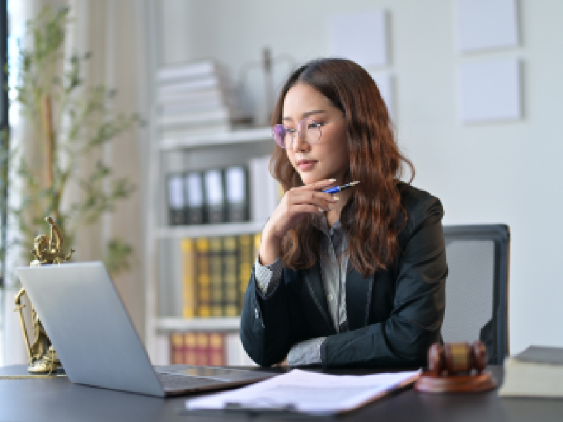 woman with long hair working at a desk