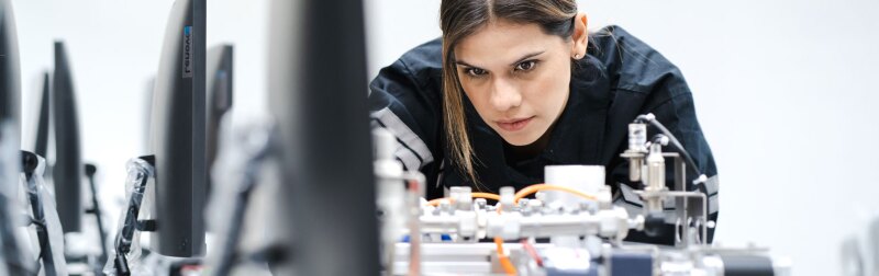 Modern people training in industry 4.0 automated engineering workshop.