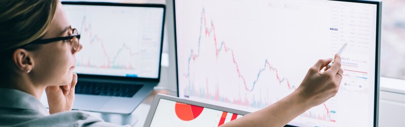 Professional woman working with graphs on computer