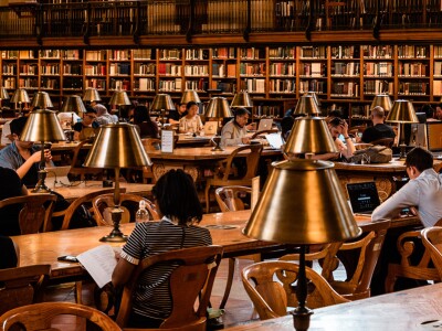 Students study at long table in a law library.