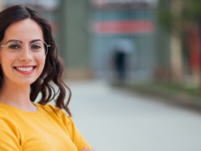 Woman in yellow sweater wearing glasses
