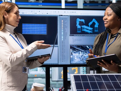Engineers discussing technology and design in a manufacturing setting.