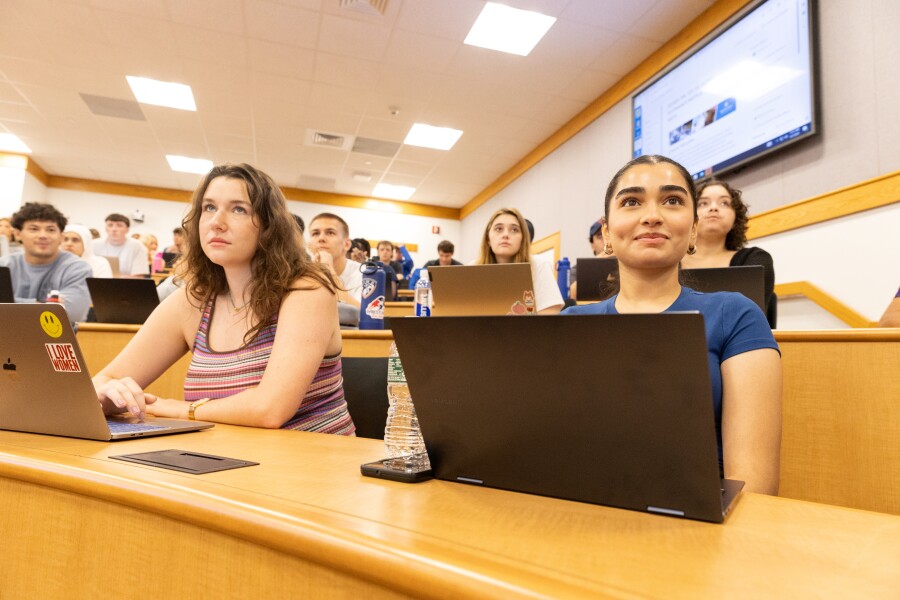 students focused on a lecture in a lecture hall