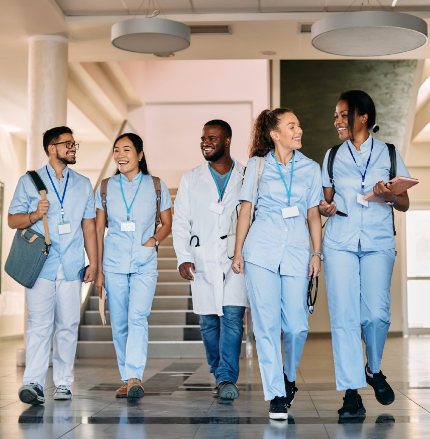 Group of uniformed medical professionals walking down a hallway
