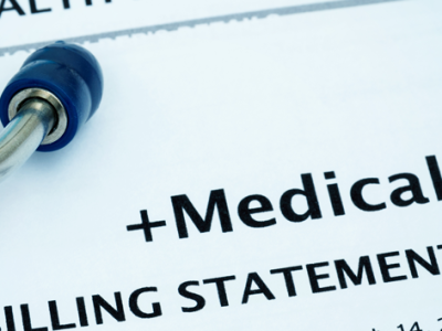 stethoscope sitting on a medical billing statement