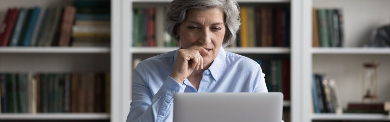 Senior female professor addressing her students in an online program.jpg