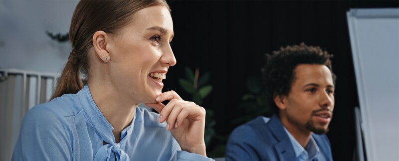 Businesswoman and colleague in office having a discussion around a table