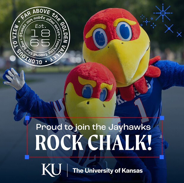 Two Kansas Jayhawks mascots smiling and posing together outdoors.