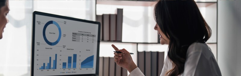 woman reading finance charts on screen