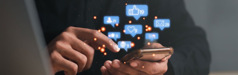 Man using a social media marketing concept on mobile phone with notification icons.