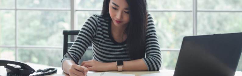 Woman studying focused at her desk