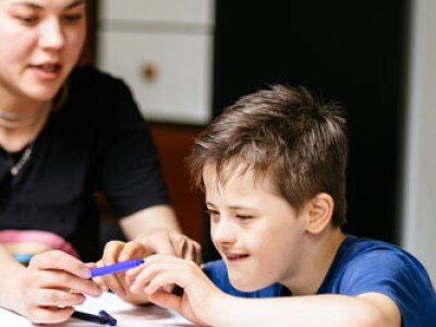 A special education teacher instructs a student.