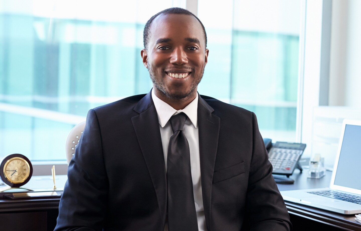 Healthcare compliance worker sitting at his desk