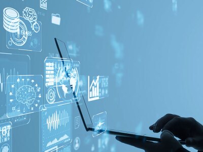 A business professional using AI-powered analytics on a laptop, surrounded by futuristic data visualizations.