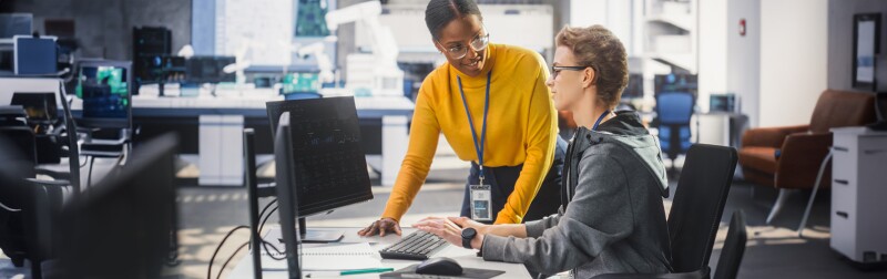 Manager Using Soft Skills to Talk with Co-Worker, Collaborating on a Technology Project.