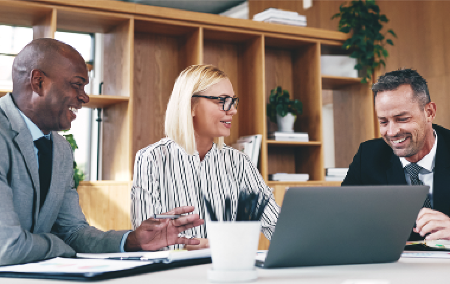 three business people reviewing data in a conference room