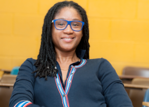 woman with glasses and yellow background