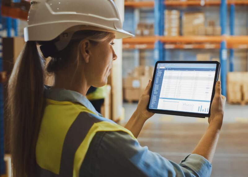 Female engineer reading spreadsheet on tablet