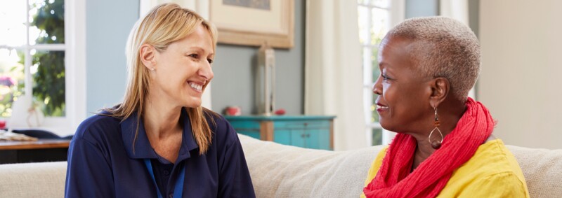 two women sitting together discussing social work