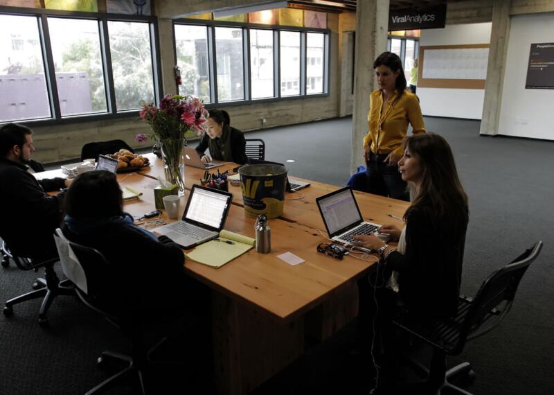 Group of colleagues collaborating around large meeting table