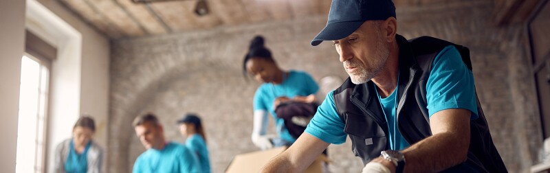 Man organizing donations in boxes at a humanitarian aid center