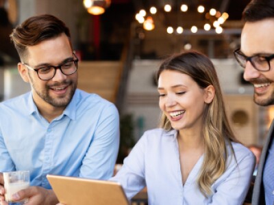 three people looking at a laptop screen