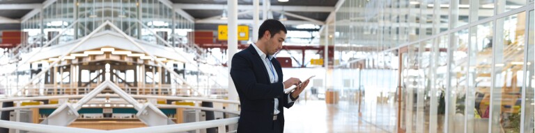 Business professional on tablet in corporate building