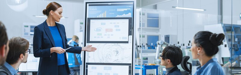 Female Engineer Uses Interactive Whiteboard, Makes Report to a Group of Engineers