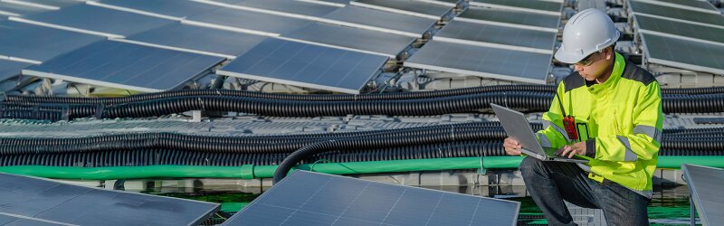 An engineer working on a set of solar panels