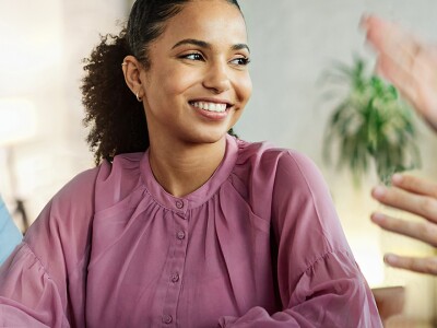 Female educator engaged in a lively discussion with colleagues