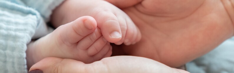 mom holding baby's feet