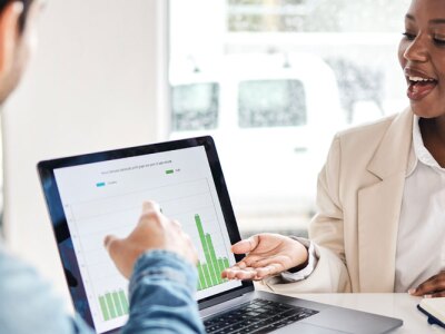 Female analysts working with business team working on customer experience analytic data.