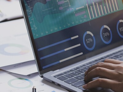 Desk with laptop showing a financial dashboard tool.
