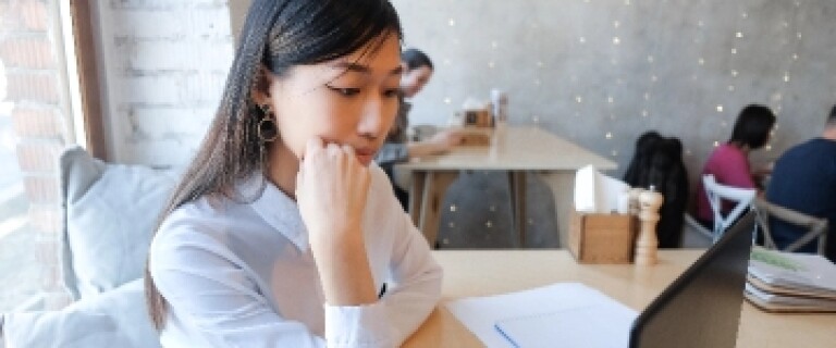 Female student studying at laptop
